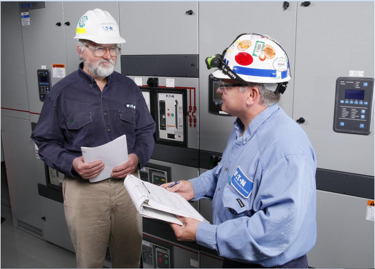 engineers talking at switchgear
