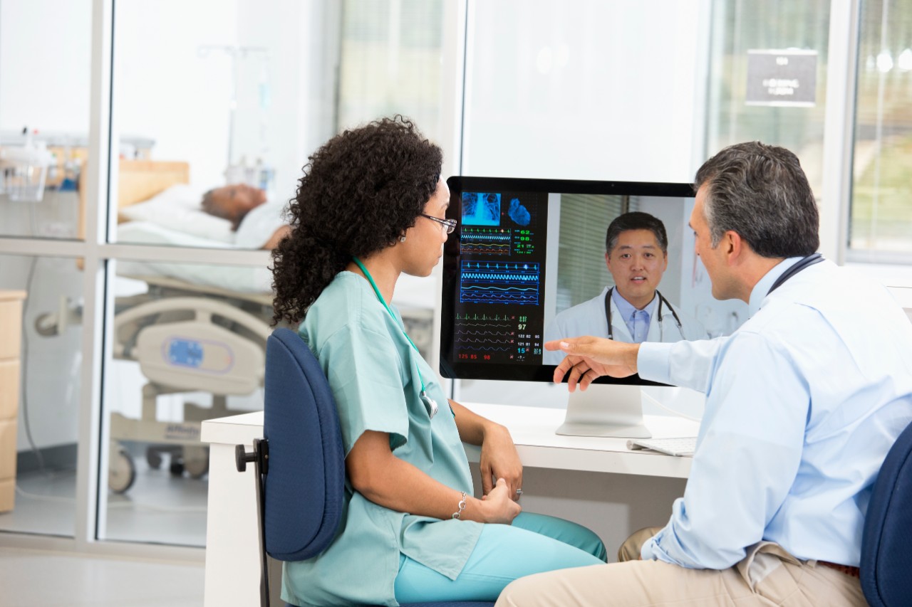 Nurse having teleconference with doctors in hospital