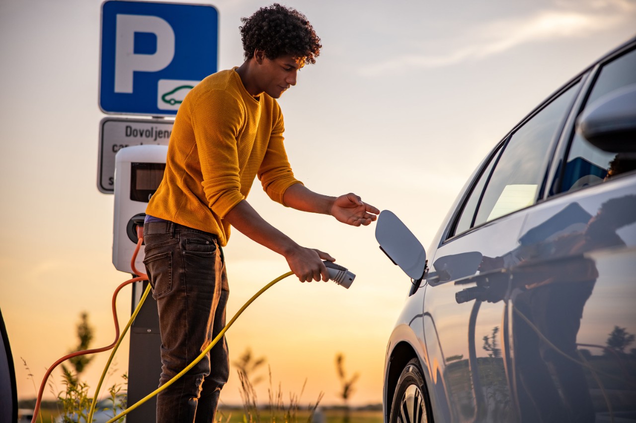 man-inserting-plug-ev-charge-car-1354074936