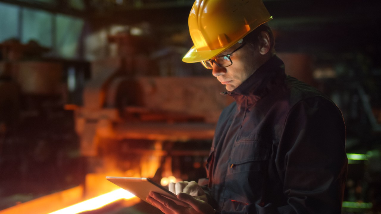 engineer-with-tablet-in-foundry-838527710