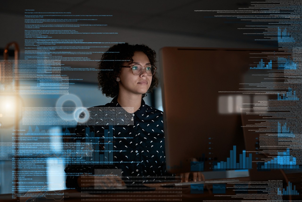 Shot of a programmer working on a computer code at night