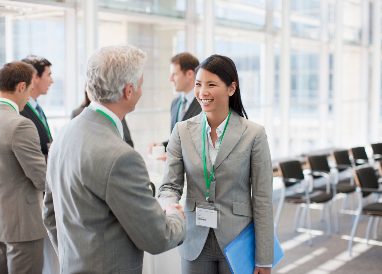 business-people-shaking-hands-at-seminar-gm-112156299