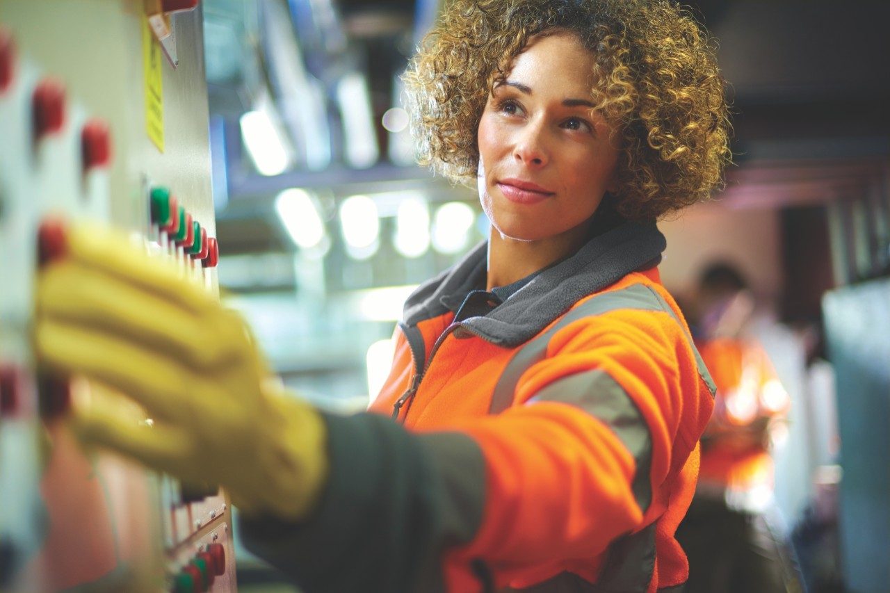 Image of a female engineer conducting safety check on low voltage switchgear