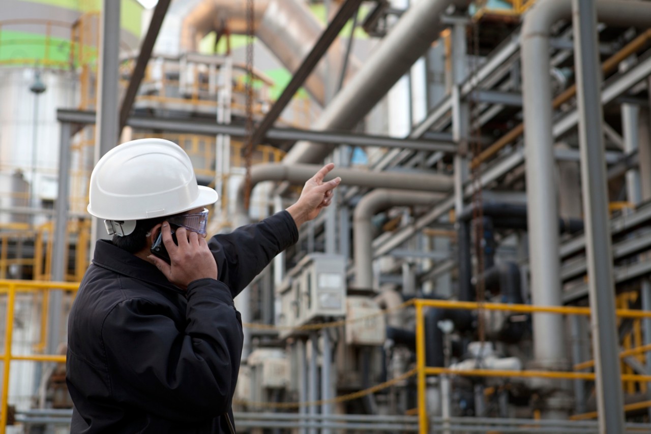 oil refinery engineer pointing against pipelinemy collection lightbox
