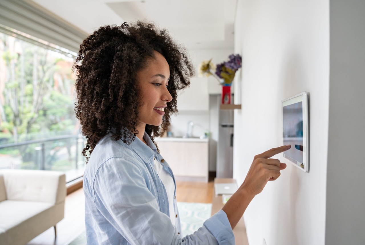 woman-using-smart-home-touchpad-getty-1208577991