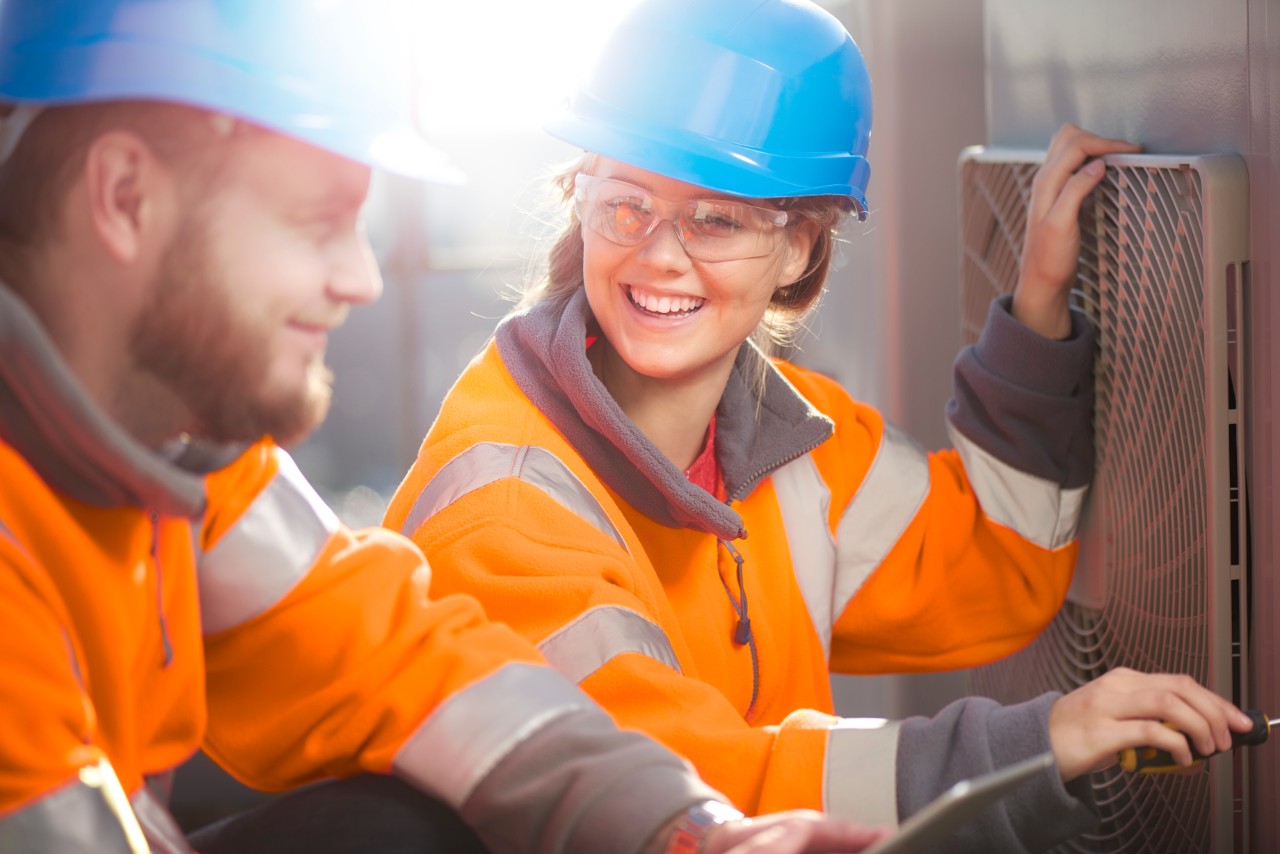 hvac-technicians-laughing-together-getty-492276080