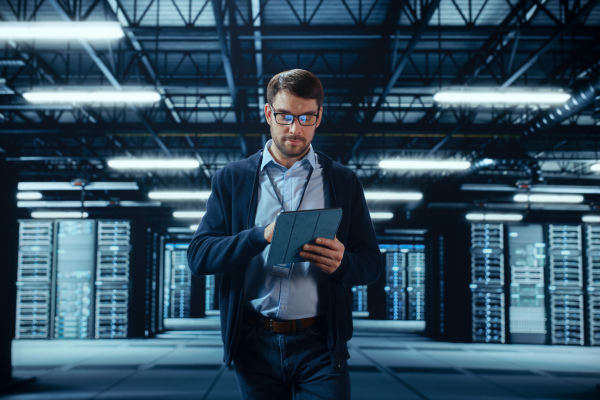 IT specialist using tablet server racks data center