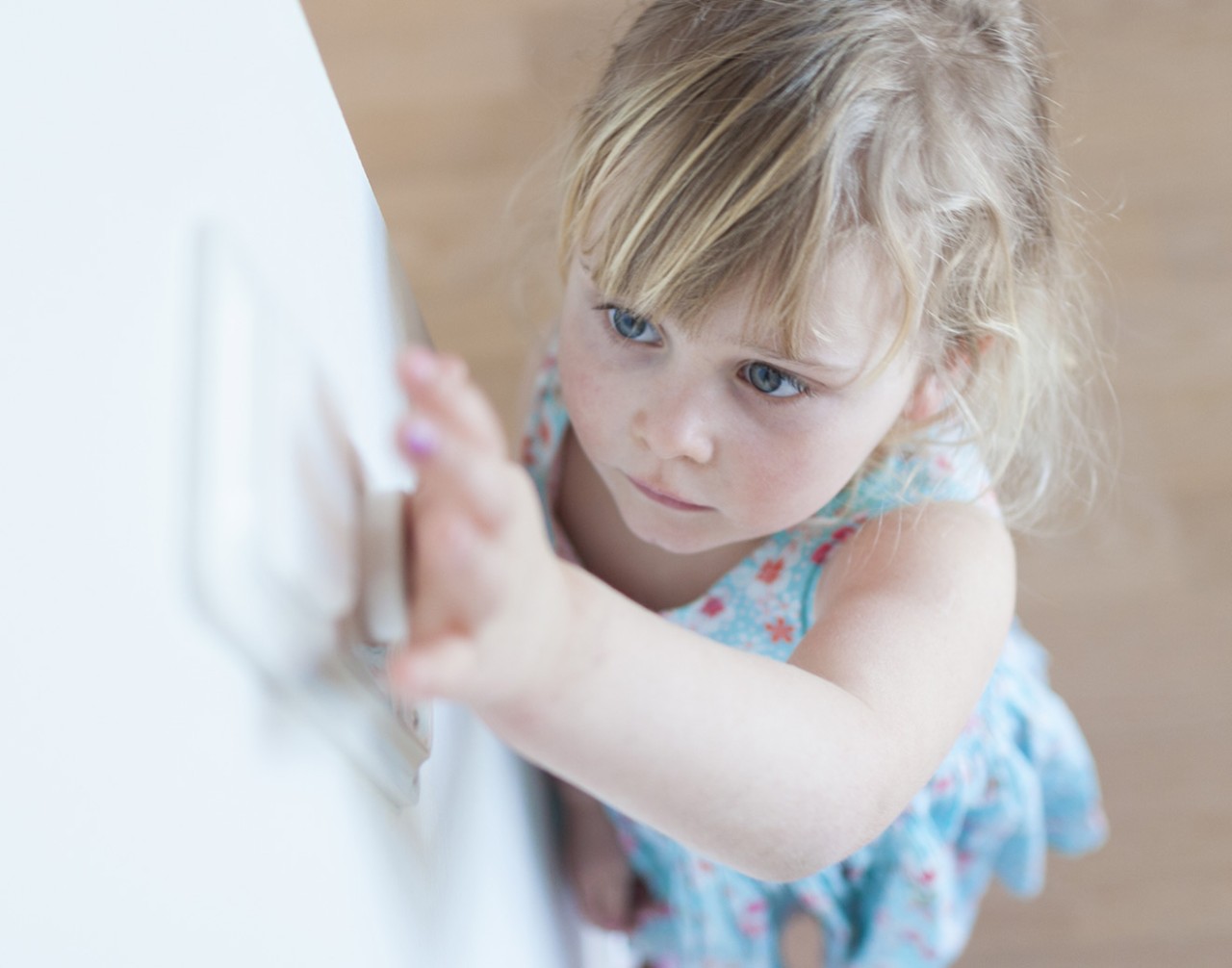 child turning off light switch