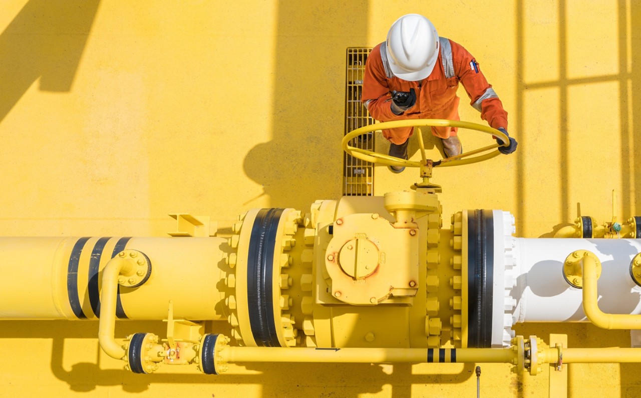 Production operator communicate between central control room by using radio to operate ball valve at offshore oil and gas processing platform for control gases and liquid crude oil process. 