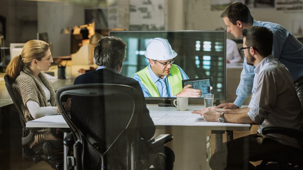 Architects and project manager in a video conference meeting with engineer.