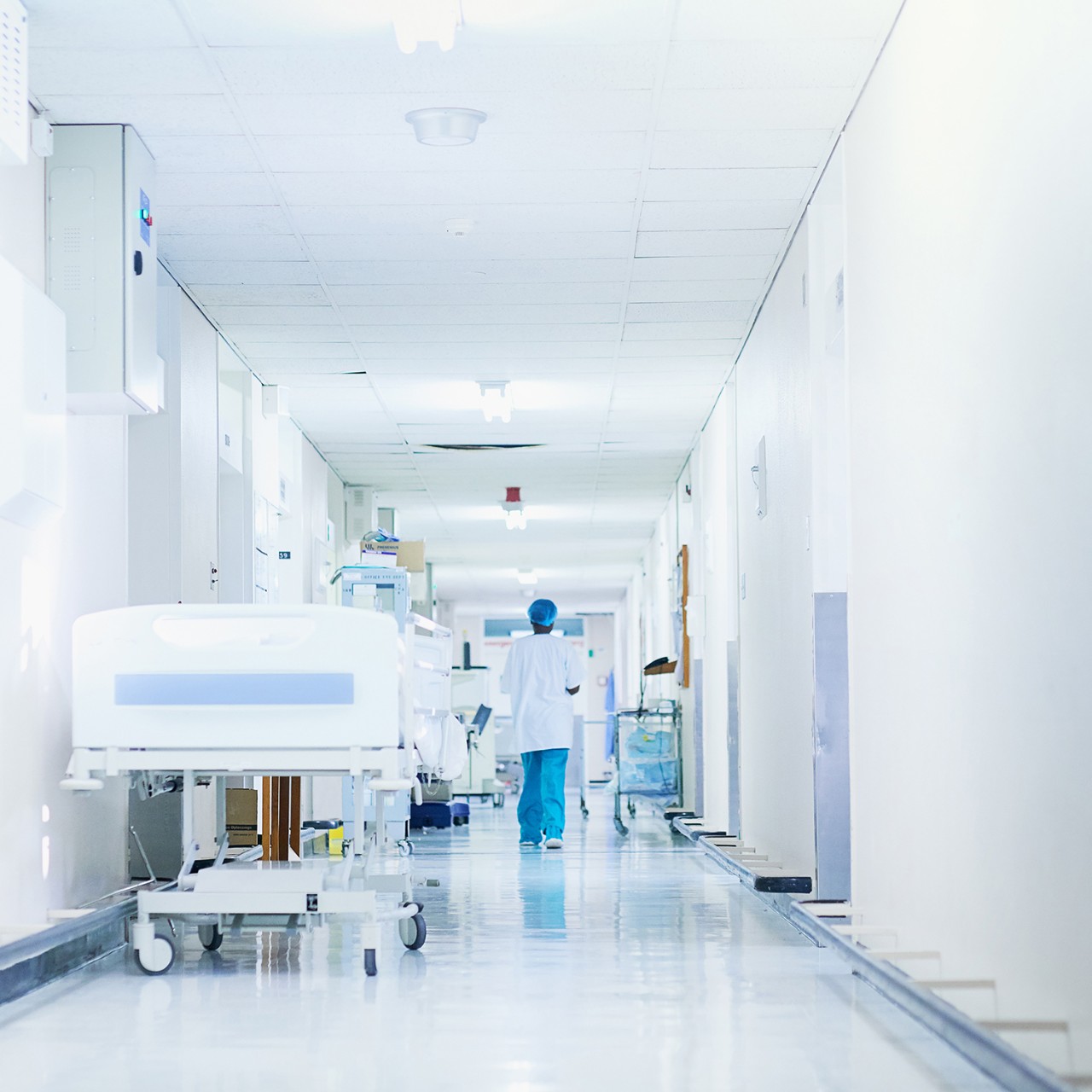 Rearview shot of a surgeon walking down a hospital corridor