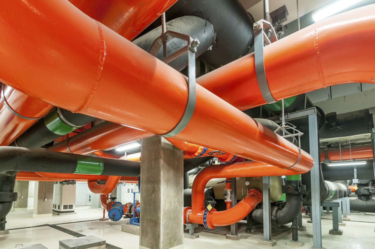 Water pumping station, industrial interior and pipes.